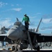 A Sailor prepares to dismount an F/A-18E Super Hornet, with Strike Fighter Squadron (VFA) 97, on the flight deck aboard the Nimitz-class aircraft carrier USS John C. Stennis (CVN 74).