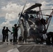 Sailors wash an MH-60S Knight Hawk, with Helicopter Sea Combat Squadron (HSC) 14, on the flight deck aboard the Nimitz-class aircraft carrier USS John C. Stennis (CVN 74).