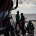Sailors wash an MH-60S Knight Hawk, with Helicopter Sea Combat Squadron (HSC) 14, on the flight deck aboard the Nimitz-class aircraft carrier USS John C. Stennis (CVN 74).