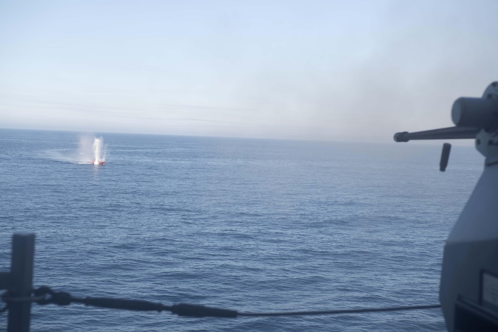 USS Spruance (DDG 111) engages a simulated surface contact with a Mark 38 25 mm machine gun system during a live fire evolution with the Arleigh Burke-class guided-missile destroyer USS Stockdale (DDG 106).
