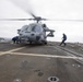 Sailors move in to remove chocks and chains from an MH-60S Sea Hawk, with Helicopter Sea Combat Squadron (HSC) 14, in preparation for lift off during flight operations aboard the Arleigh Burke-class guided-missile destroyer USS Spruance (DDG 111).