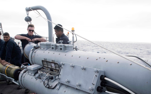 Sailors perform maintenance on the torpedo launch system aboard USS Spruance (DDG 111).