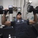 Chief Damage Controlman Marcus White lifts weights in the gym aboard USS Spruance (DDG 111).