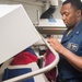 Ship’s Serviceman 3rd Class Corey Williams presses napkins for the mess decks aboard USS Mobile Bay (CG 53).