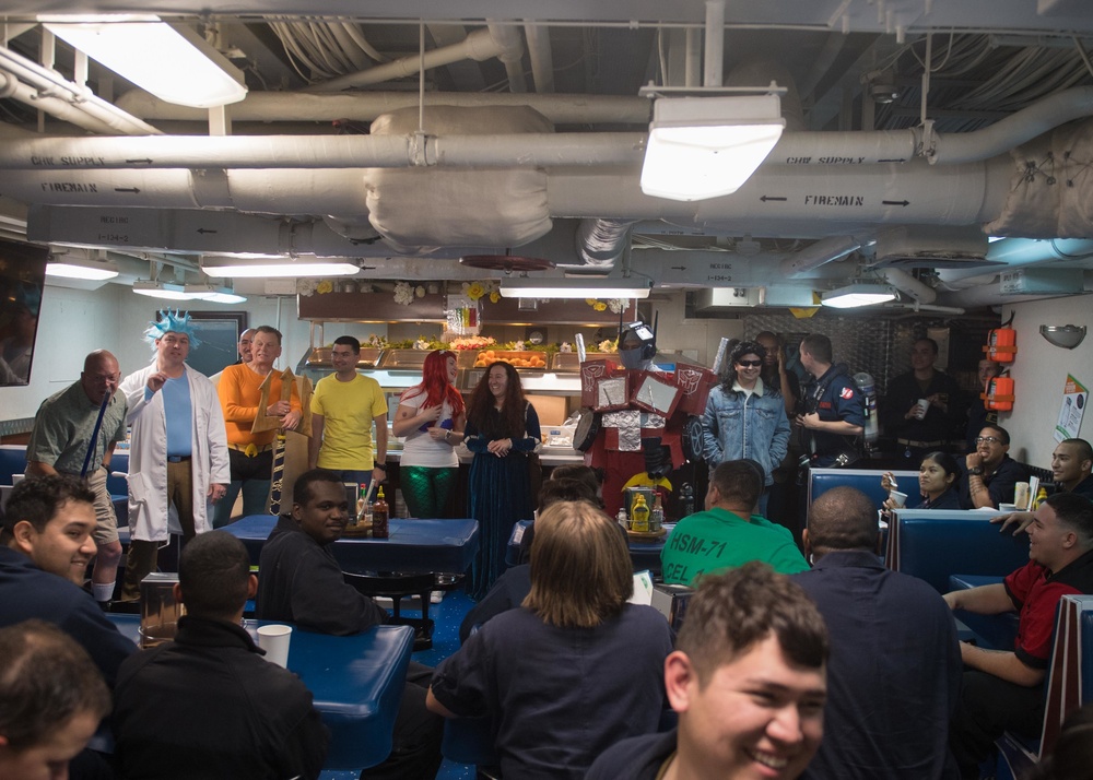 Sailors compete in a costume contest with their peers as judges aboard USS Mobile Bay (CG 53).