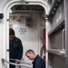 Information Systems Technician 3rd Class Alexander Apin, left, and Seaman Zachary Greco conduct maintenance on a watertight door aboard USS Stockdale (DDG 106).