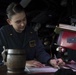 Ens. Helen Robertson completes a maneuvering board solution while standing watch as the junior officer of the deck (JOOD) in the pilot house aboard USS Spruance (DDG 111).