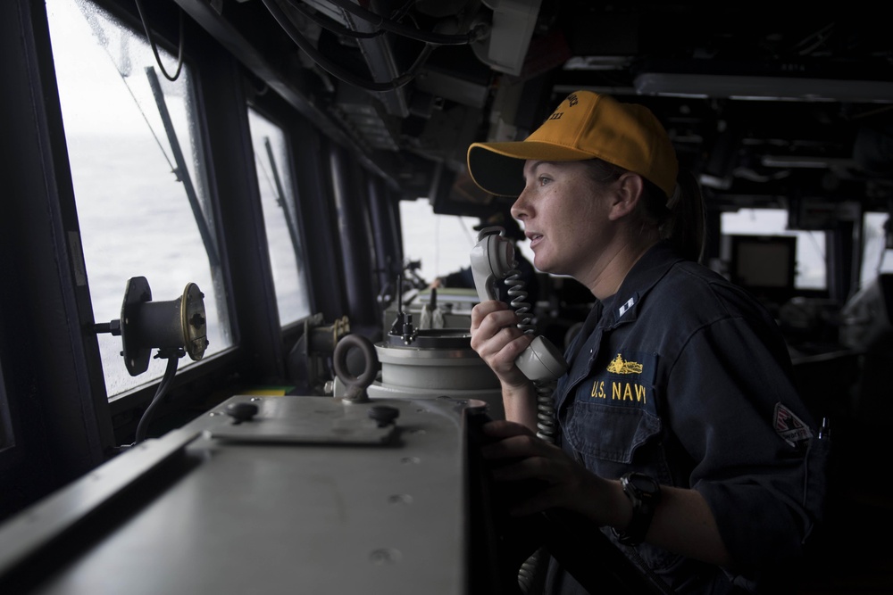 Lt. Kristin Rovito passes a message as the officer of the deck in the pilot house aboard USS Spruance (DDG 111).