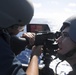 Gunner’s Mate 2nd Class Tristan Fields, right, advises Gunner’s Mate Seaman Apprentice Jonathan Ruiz as he fires an M240B machine gun aboard USS Spruance (DDG 111).