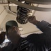 Electrician's Mate 2nd Class Alexander Tramel troubleshoots the recover, assist, secure and traverse system (RAST) aboard USS Mobile Bay (CG 53).