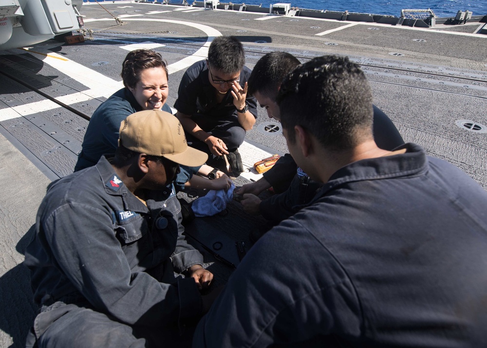 Sailors repair a wire along the electrical cable assembly aboard the flight deck of USS Mobile Bay (CG 53).