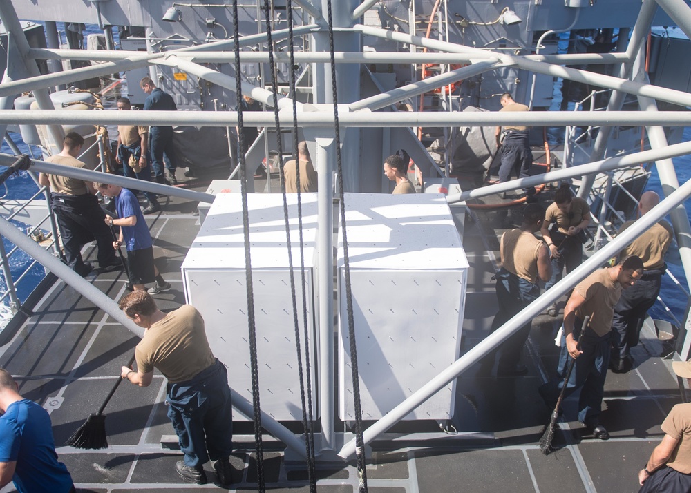 Sailors participate in a fresh water washdown onboard USS Mobile Bay (CG 53).