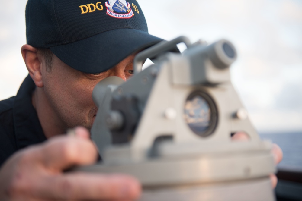 Chief Warrant Officer 3 Dustin Armstrong uses a bearing circle aboard USS Chung-Hoon (DDG 93).