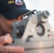 Chief Warrant Officer 3 Dustin Armstrong uses a bearing circle aboard USS Chung-Hoon (DDG 93).