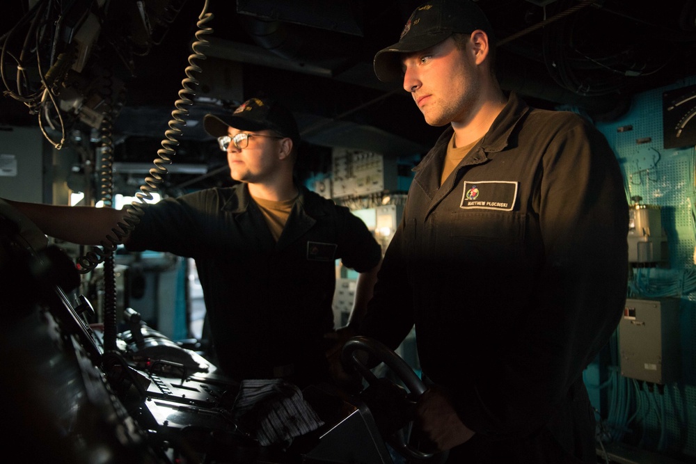 Seaman Matthew Plucinski, right, and Seaman Aaron Kiefer stand watch in the pilot house aboard USS Chung-Hoon (DDG 93).