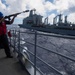 Gunner's Mate 3rd Class Daniel Zhang fires a shot line to USNS Guadalupe (T-AO 200) during a replenishment-at-sea (RAS) aboard  USS Mobile Bay (CG 53).