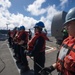 Sonar Technician (Surface) Nick Herman handles the phone and distance line aboard USS Mobile Bay (CG 53) during a replenishment-at-sea.