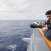 Cryptologic Technician (Collection) Seaman Sam Keilty takes photos as part of the visual information team aboard USS Mobile Bay (CG 53).