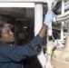 Logistics Specialist 2nd Class Nakosha Embry wipes down pipes and wires during cleaning stations aboard USS Spruance (DDG 111).