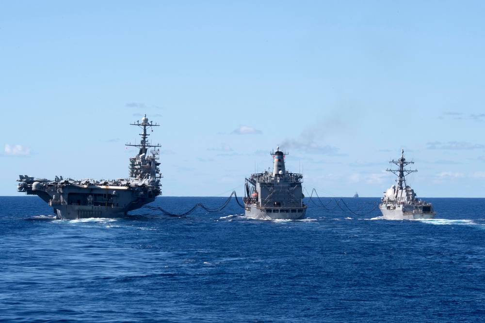 USS John C. Stennis (CVN 74), left, and USS Chung-Hoon (DDG 93), right, receive fuel from USNS Guadalupe (T-AO 200) during a replenishment-at-sea.