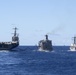 USS John C. Stennis (CVN 74), left, and USS Chung-Hoon (DDG 93), right, receive fuel from USNS Guadalupe (T-AO 200) during a replenishment-at-sea.