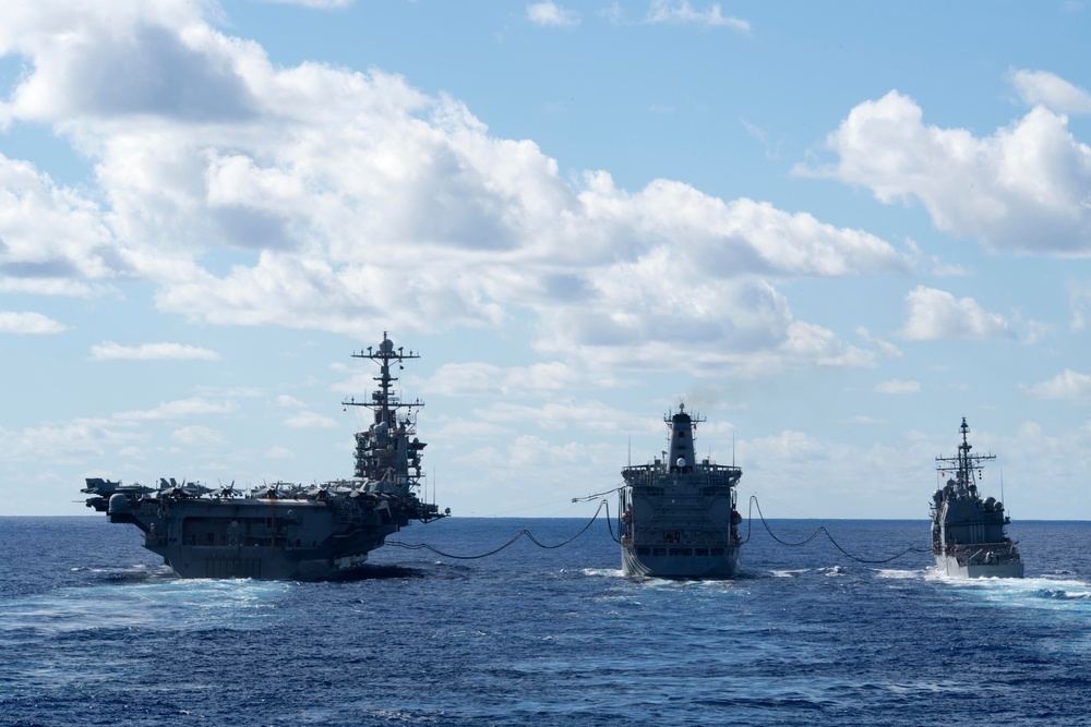 USS John C. Stennis (CVN 74), left, and USS Mobile Bay (CG 53), right, receive fuel from USNS Guadalupe (T-AO 200) during a replenishment-at-sea.