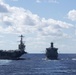 USS John C. Stennis (CVN 74), left, and USS Mobile Bay (CG 53), right, receive fuel from USNS Guadalupe (T-AO 200) during a replenishment-at-sea.