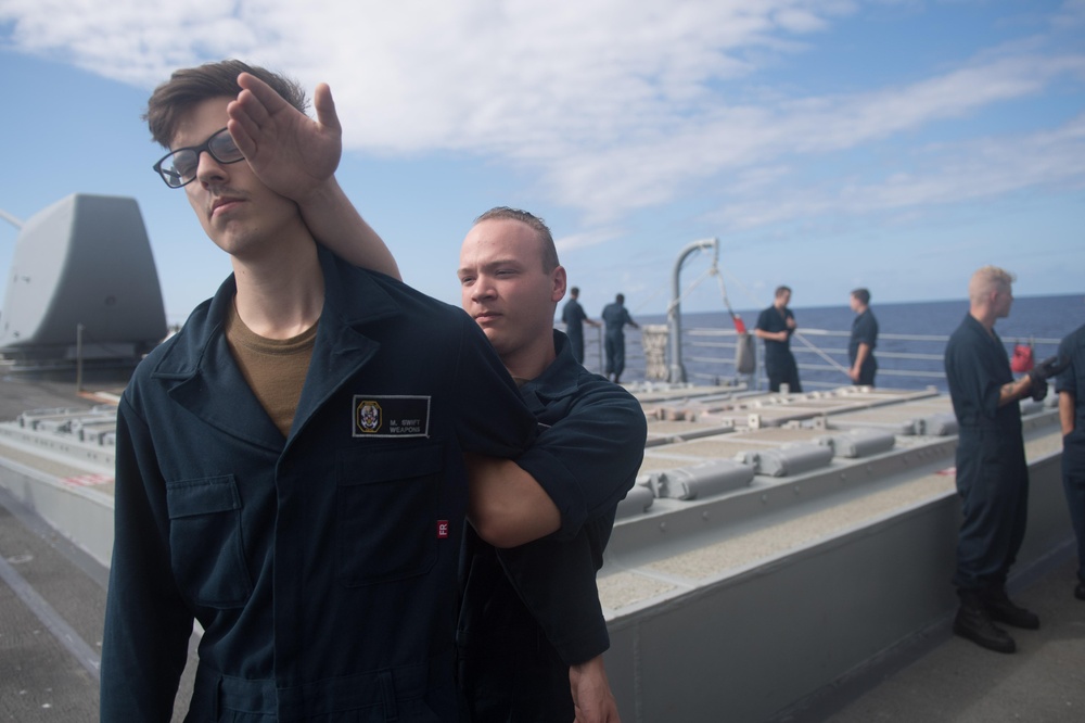 Sonar Technician (Surface) 2nd Class Conner Stampfli practices a Mechanical Advantage Control Hold (MACH) takedown as part of the security reaction force basic training course aboard USS Mobile Bay (CG 53).