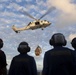 Sailors wait to retrieve cargo as an MH-60S Sea Haw lowers supplies onto the flight deck of USS Spruance (DDG 111) during a vertical replenishment.