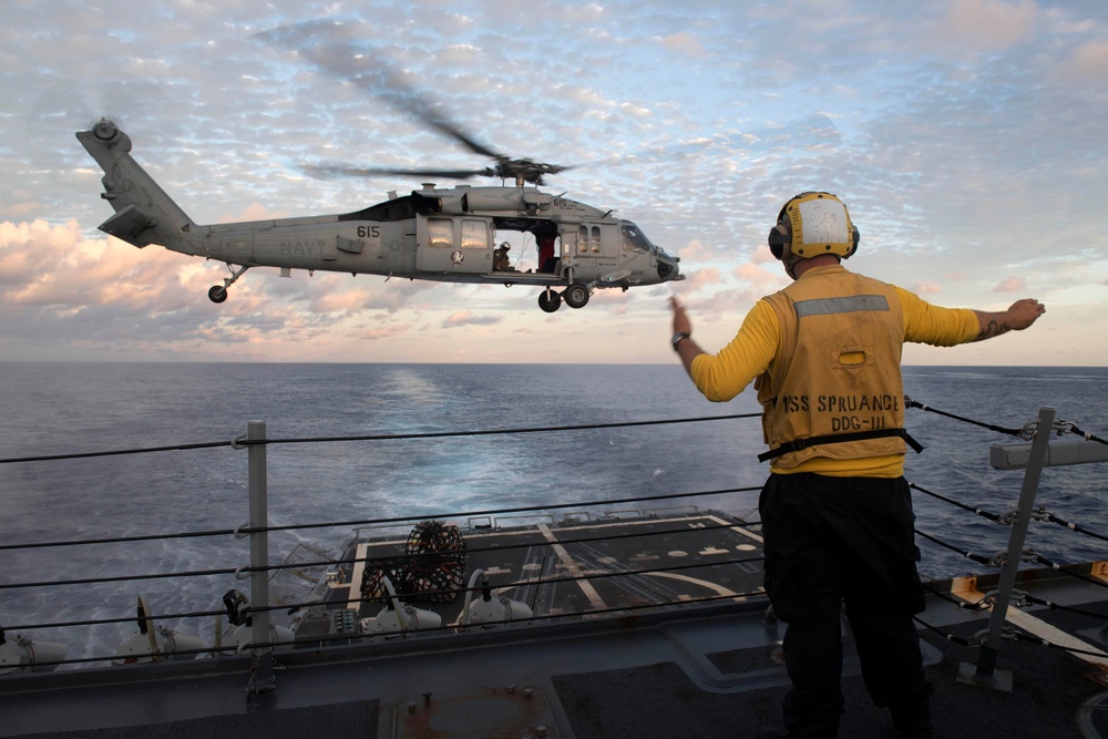 Boatswain’s Mate 2nd Class Brian Bruni signals the pilot of an MH-60S Sea Hawk during a vertical replenishment.