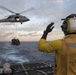 Boatswain’s Mate 2nd Class Ibrahim Kaba signals the pilot of an MH-60S Sea Hawk during a vertical replenishment.