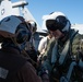 Rear Adm. Michael Wettlaufer, commander, Carrier Strike Group (CSG) 3, shakes hands with a Sailor after conducting a pre-flight inspection on an EA-18G Growler on the flight deck aboard the Nimitz-class aircraft carrier USS John C. Stennis (CVN 74).