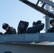Rear Adm. Michael Wettlaufer, commander, Carrier Strike Group (CSG) 3, left, and Capt. Steven Hejmanowski, commander, Carrier Airwing (CVW) 9, prepare for flight operations in an EA-18G Growler on the flight deck USS John C. Stennis (CVN 74).