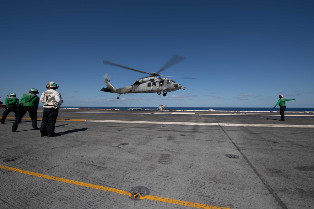 An MH-60S Knight Hawk, with Helicopter Sea Combat Squadron (HSC) 14, takes off from the flight deck aboard USS John C. Stennis (CVN 74).