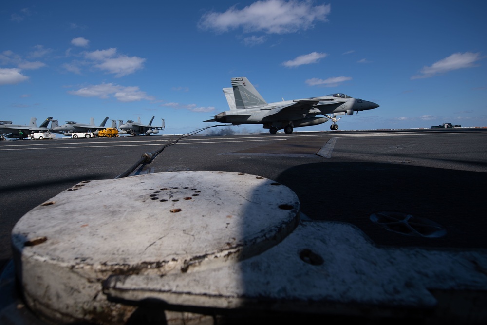 An F/A-18E Super Hornet, with Strike Fighter Squadron (VFA) 151, catches an arresting gear wire while landing on the flight deck aboard USS John C. Stennis (CVN 74).