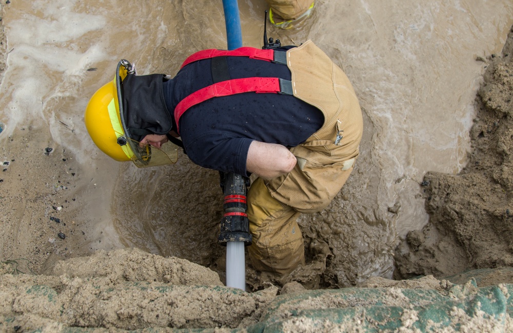 Soldiers and Firefighters Clean up After Flooding at Camp Arifjan