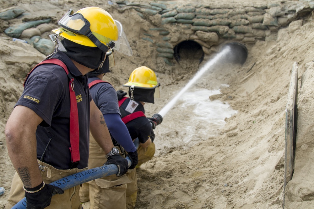 Soldiers and Firefighters Clean up After Flooding at Camp Arifjan