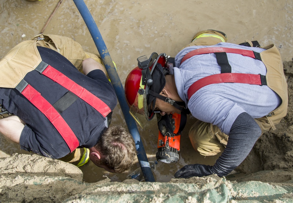 Soldiers and Firefighters Clean up After Flooding at Camp Arifjan