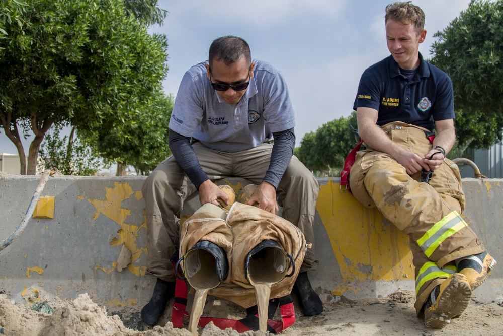 Soldiers and Firefighters Clean up After Flooding at Camp Arifjan