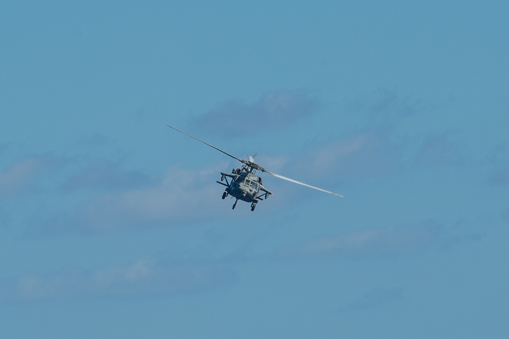 An MH-60S Knight Hawk, with Helicopter Sea Combat Squadron (HSC) 14, flies during a dual carrier strike force exercise. John C. Stennis is underway and conducting operations in international waters as part of a dual carrier strike force exercise.