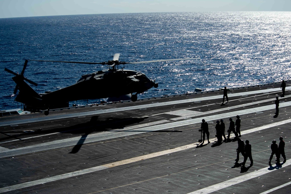 n MH-60S Knight Hawk, with Helicopter Sea Combat Squadron (HSC) 14, prepares to land on the flight deck aboard  USS John C. Stennis (CVN 74).