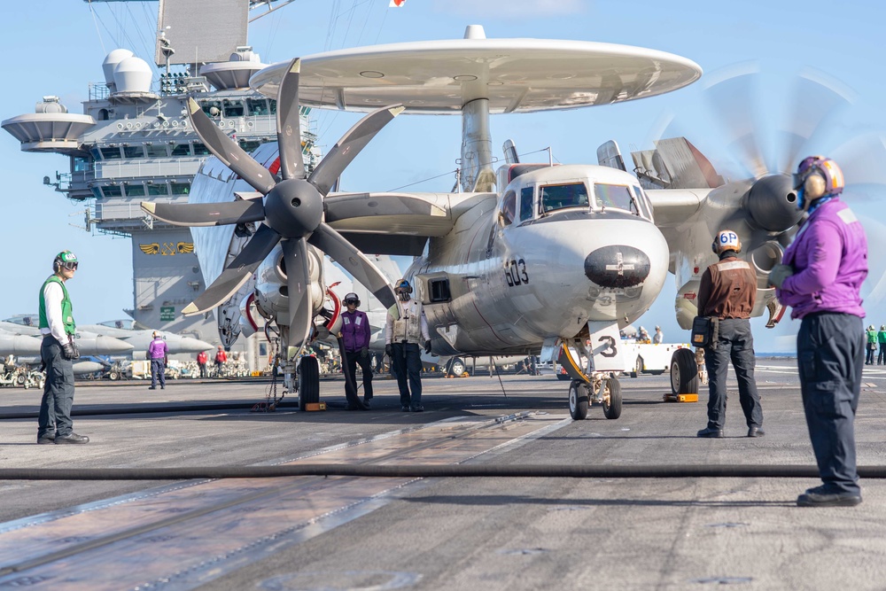 Sailors fuel an E-2C Hawkeye before flight operations aboard USS John C. Stennis (CVN 74).