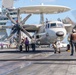 Sailors fuel an E-2C Hawkeye before flight operations aboard USS John C. Stennis (CVN 74).