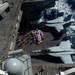 Sailors move mail from an aircraft elevator into the hangar bay during a mail call aboard USS John C. Stennis (CVN 74).