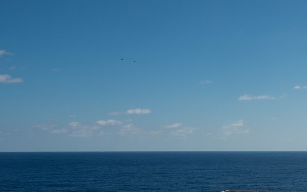An F/A-18E Super Hornet, left, with Strike Fighter Squadron (VFA) 14, takes off from the flight deck aboard USS John C. Stennis (CVN 74).