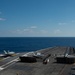 An F/A-18E Super Hornet, left, with Strike Fighter Squadron (VFA) 14, takes off from the flight deck aboard USS John C. Stennis (CVN 74).