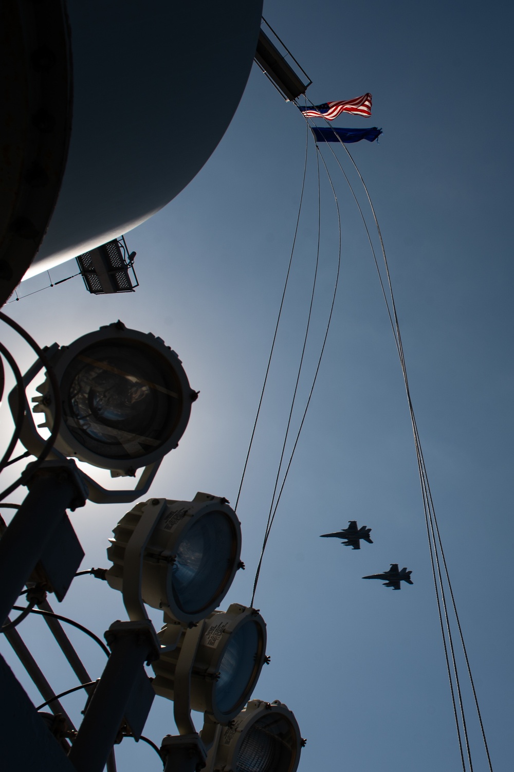 Two EA-18G Growlers, with Electronic Attack Squadron (VAQ) 133, fly in formation over the flight deck of USS John C. Stennis (CVN 74).