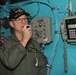 Commander, Carrier Strike Group 3, Rear Adm. Mike Wettlaufer, uses the 1MC system in the pilot house of USS Chung-Hoon (DDG 93) to address the  crew.