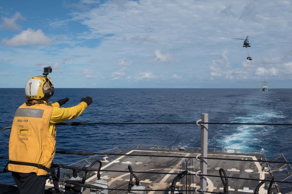 Ship’s Serviceman 3rd Class Ruby McCullough guides an MH-60R Sea Hawk, with Helicopter Maritime Strike Squadron 37, to the flight deck of USS Chung-Hoon (DDG 93) during a vertical replenishment.