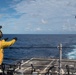 Ship’s Serviceman 3rd Class Ruby McCullough guides an MH-60R Sea Hawk, with Helicopter Maritime Strike Squadron 37, to the flight deck of USS Chung-Hoon (DDG 93) during a vertical replenishment.